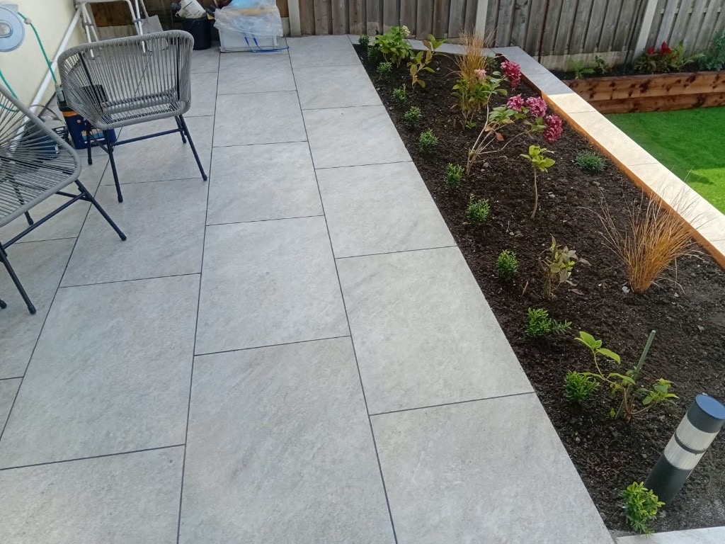 flower beds and porcelain patio